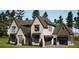 Stunning traditional new home exterior elevation featuring a three car garage at 6740 Pannell Rd, Buford, GA 30518