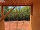 Framed window opening to exterior, with trees and unfinished yard beyond at 6740 Pannell Rd, Buford, GA 30518