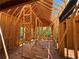 Home framing with exposed beams and placement for windows overlooking green trees at 6740 Pannell Rd, Buford, GA 30518