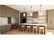 Modern kitchen with a marble backsplash, an island with seating, stainless steel appliances, and open shelving at 6740 Pannell Rd, Buford, GA 30518