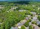 Community aerial view surrounded by beautiful green trees, featuring gorgeous homes and community amenities at 10410 High Falls Cir, Alpharetta, GA 30022