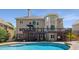 Expansive backyard features a pool, patio, and lush landscaping, creating a private oasis for relaxation and enjoyment at 10410 High Falls Cir, Alpharetta, GA 30022