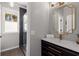 Modern bathroom featuring elegant fixtures, a decorative mirror, and a glass-enclosed shower at 10410 High Falls Cir, Alpharetta, GA 30022