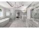 Luxurious bathroom featuring a soaking tub, glass-enclosed shower, and dual vanities at 10410 High Falls Cir, Alpharetta, GA 30022