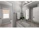 Bright bathroom featuring a granite countertop, white cabinets, and tile flooring at 10410 High Falls Cir, Alpharetta, GA 30022