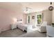 Cozy bedroom with white furniture, soft lighting, and a comfortable reading chair at 10410 High Falls Cir, Alpharetta, GA 30022