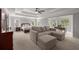 Spacious main bedroom featuring a sitting area, ceiling fan, and abundant natural light from many windows at 10410 High Falls Cir, Alpharetta, GA 30022