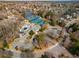 Community aerial featuring tennis courts, swimming pool, playground, parking lot, and lake at 10410 High Falls Cir, Alpharetta, GA 30022