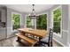Dining area with an exposed wood table and views of the backyard and deck at 10410 High Falls Cir, Alpharetta, GA 30022