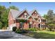 Two story brick home with a manicured lawn and a side entry garage at 10410 High Falls Cir, Alpharetta, GA 30022