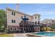 Well-maintained exterior with a deck, lower patio, and access to the pool, offering multiple outdoor living spaces at 10410 High Falls Cir, Alpharetta, GA 30022