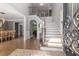 Open foyer with staircase featuring hardwood floors leading to multiple rooms at 10410 High Falls Cir, Alpharetta, GA 30022