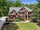 Elegant brick home featuring manicured landscaping and a classic architectural design at 10410 High Falls Cir, Alpharetta, GA 30022