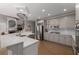 Bright open concept kitchen with white marble countertops and stainless steel appliances at 10410 High Falls Cir, Alpharetta, GA 30022