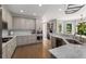 Bright open concept kitchen with stainless steel appliances and gas range at 10410 High Falls Cir, Alpharetta, GA 30022