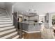 Kitchen with white countertops and stainless steel appliances viewed from the nearby stairs at 10410 High Falls Cir, Alpharetta, GA 30022