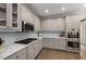 Modern kitchen with a gas range, stainless steel appliances, and white backsplash at 10410 High Falls Cir, Alpharetta, GA 30022