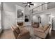 Bright living room featuring a fireplace, hardwood floors, lots of natural light, and built-in bookshelves at 10410 High Falls Cir, Alpharetta, GA 30022