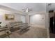 Spacious living room with a comfortable leather couch, neutral walls, and a ceiling fan at 10410 High Falls Cir, Alpharetta, GA 30022