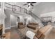Open-concept living room featuring a fireplace, hardwood floors, lots of natural light and access to the kitchen at 10410 High Falls Cir, Alpharetta, GA 30022