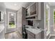 Office nook near the kitchen with storage cabinets, a desk, and views of the outside at 10410 High Falls Cir, Alpharetta, GA 30022