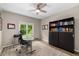 Bright office features a large window with natural light and a ceiling fan for enhanced air circulation at 10410 High Falls Cir, Alpharetta, GA 30022