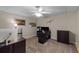 Home office with desk, comfortable office chair, ceiling fan, and neutral decor at 10410 High Falls Cir, Alpharetta, GA 30022