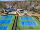Aerial view of community tennis courts, pool, and playground providing recreation opportunities at 10410 High Falls Cir, Alpharetta, GA 30022