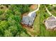 Aerial view of a stately home with a backyard deck and lush landscaping at 12980 Overlook Pass, Roswell, GA 30075