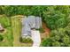 Aerial view of a well-maintained brick home surrounded by lush greenery, creating a serene setting at 12980 Overlook Pass, Roswell, GA 30075