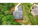 Stunning aerial view of a luxurious home with a long driveway and lush landscaping, surrounded by trees at 12980 Overlook Pass, Roswell, GA 30075