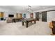Basement featuring a pool table, large screen TV, and barn door accent at 12980 Overlook Pass, Roswell, GA 30075