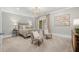 Comfortable bedroom with neutral colors, patterned chairs, bedside tables, and a decorative light fixture at 12980 Overlook Pass, Roswell, GA 30075