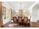 Charming dining room with elegant lighting, hardwood flooring, and soft neutral tones at 12980 Overlook Pass, Roswell, GA 30075