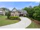 Handsome home with a stone and brick facade, mature landscaping, and an inviting front entrance at 12980 Overlook Pass, Roswell, GA 30075