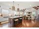 Open-concept kitchen with island seating, stainless sink, and flows into the living area at 12980 Overlook Pass, Roswell, GA 30075