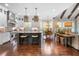 Gourmet kitchen with island seating, stainless appliances, and hardwood floors at 12980 Overlook Pass, Roswell, GA 30075