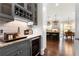 Stylish kitchen with custom cabinets, wine rack, and marble countertops at 12980 Overlook Pass, Roswell, GA 30075