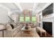 Inviting living room with fireplace, large windows, and ample seating at 12980 Overlook Pass, Roswell, GA 30075