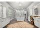 Elegant main bathroom featuring a soaking tub, dual vanities, and decorative wallpaper at 12980 Overlook Pass, Roswell, GA 30075