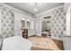 Chic main bathroom with a freestanding tub, vanity area, and stylish wallpaper at 12980 Overlook Pass, Roswell, GA 30075