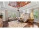 Luxurious main bedroom featuring a wood tray ceiling, chandelier, and elegant furnishings at 12980 Overlook Pass, Roswell, GA 30075