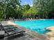Large, refreshing community pool surrounded by lounge chairs and lots of greenery at 12980 Overlook Pass, Roswell, GA 30075