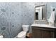 Stylish powder room with designer wallpaper, modern vanity, and elegant fixtures at 12980 Overlook Pass, Roswell, GA 30075
