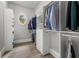 Walk-in closet features custom shelving, drawers, and a small window allowing in natural light at 12980 Overlook Pass, Roswell, GA 30075