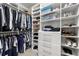 Walk-in closet with custom white shelving, clothes racks, shoe storage, and plenty of organizational space at 12980 Overlook Pass, Roswell, GA 30075