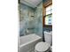 Bathroom featuring blue tile shower, window and toilet at 1429 Smithson Dr, Lithonia, GA 30058
