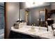 Bathroom with a marble sink and vanity mirror reflecting the blue tiled shower and bedroom beyond at 1429 Smithson Dr, Lithonia, GA 30058