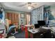 This cluttered bedroom features a ceiling fan, closet, and desk with computer setup at 1429 Smithson Dr, Lithonia, GA 30058