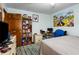 Bedroom featuring a bed, a desk, a dresser and light blue walls at 1429 Smithson Dr, Lithonia, GA 30058